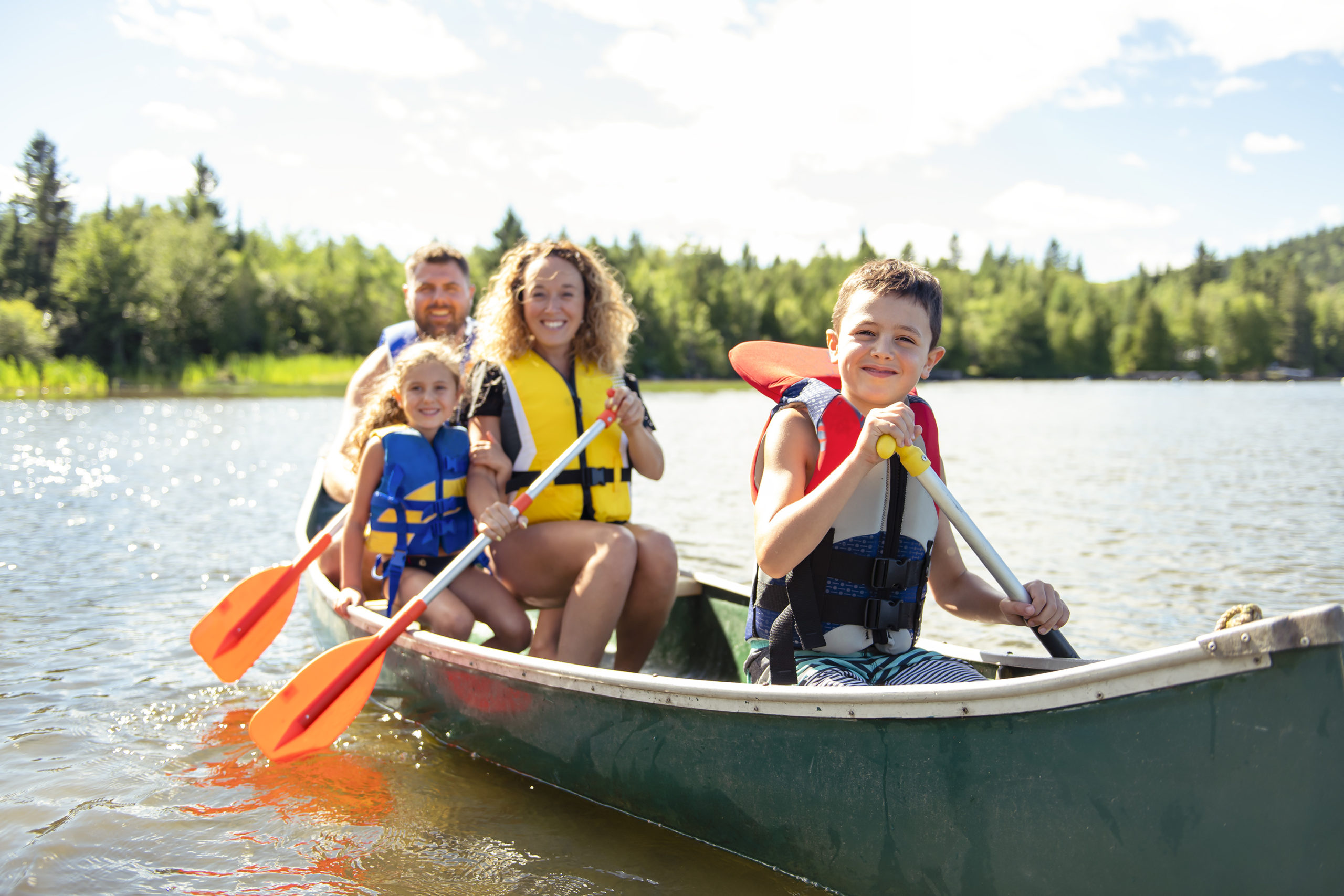 Family in a Canoe on a Lake having fun Family in a canoe