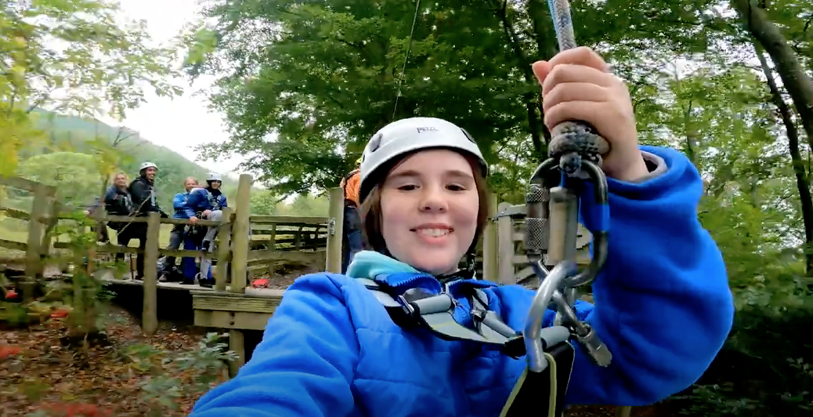Girl on zip line at StepIn Camp in Lake District